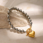 Silver Bead Bracelet with Gold Heart Pendant, Elegant and Minimalist Design